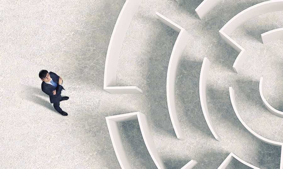 man standing outside of a maze